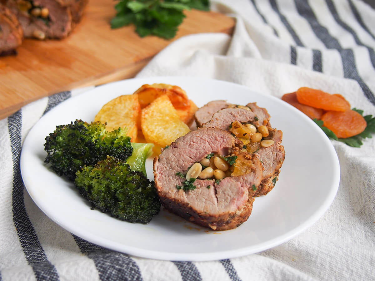 apricot stuffed pork tenderloin with broccoli and potatoes on plate