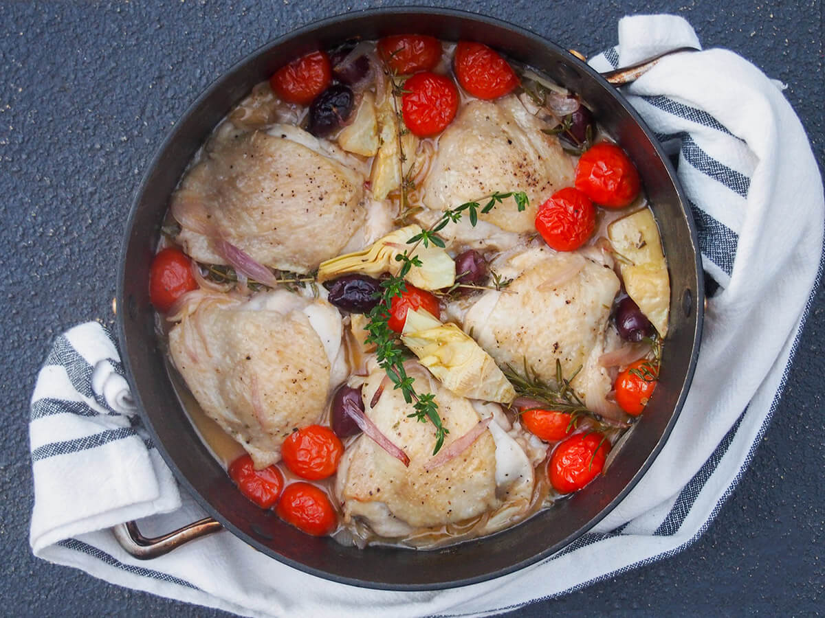 dish with chicken provencal with cloth looped in handles of dish