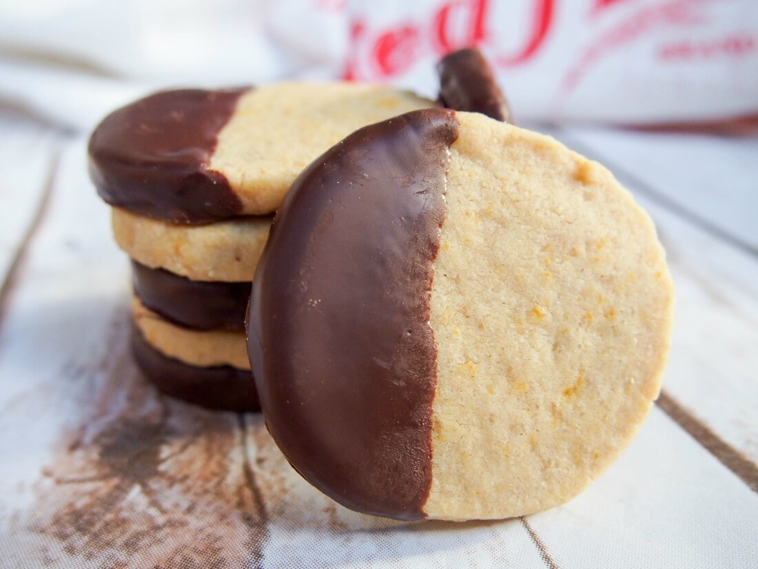 chocolate orange shortbread cookies with one at front resting against stack