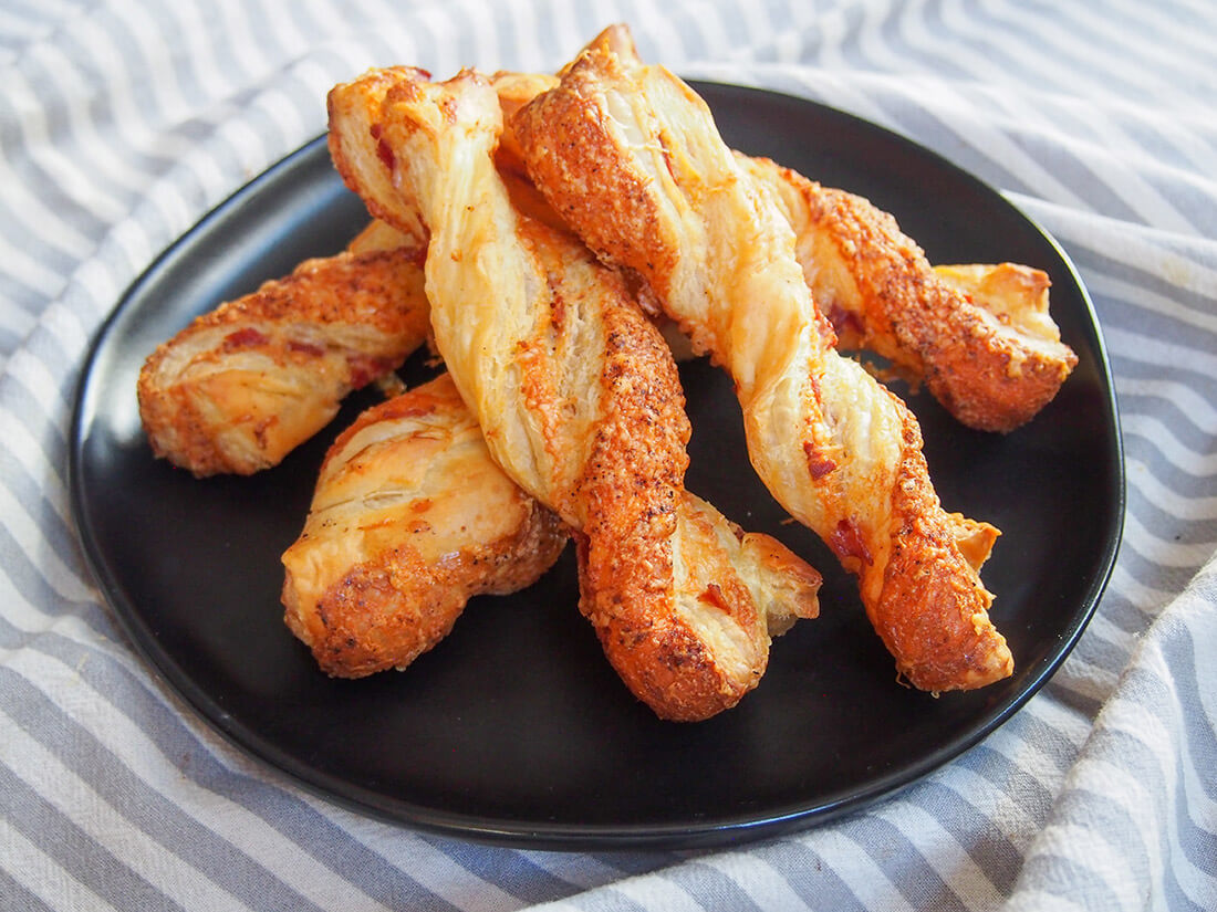 plate of chorizo cheese twists stacked in middle