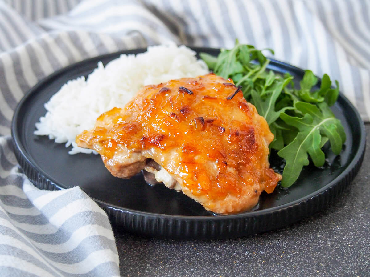 chutney chicken with rice and salad behind