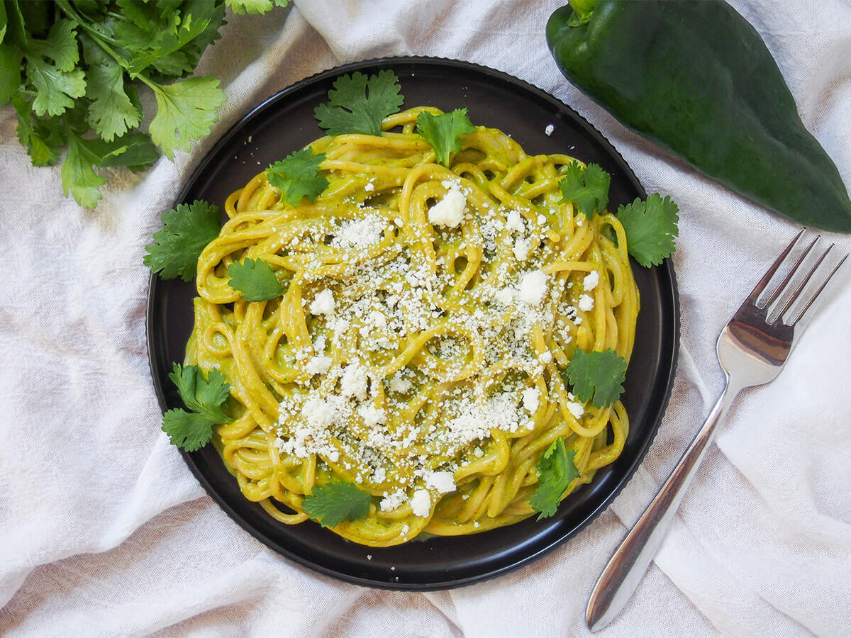 plate of espagueti verde Mexican green spaghetti with fork to side