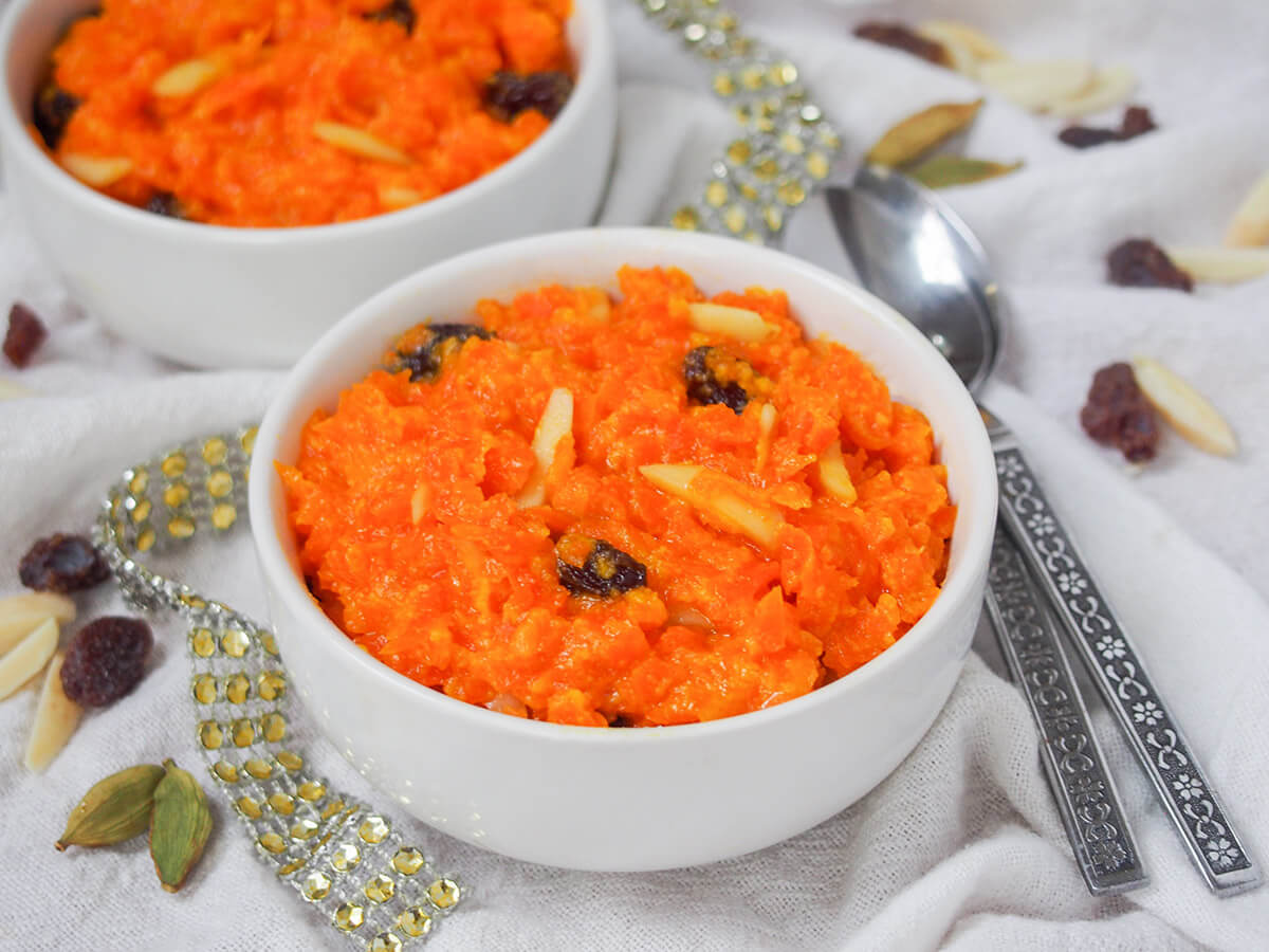 side view of bowl of gajar halwa carrot pudding.