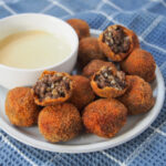 plate of haggis bon bons with some broken on top.