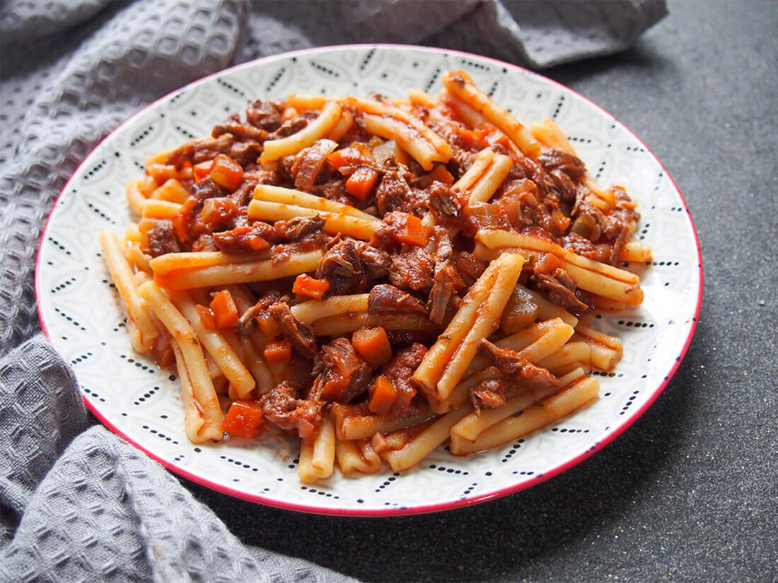 lamb ragu pasta on plate