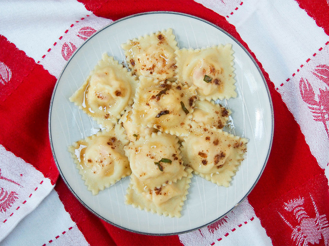 Plate of lobster ravioli on lobster-decorated towel