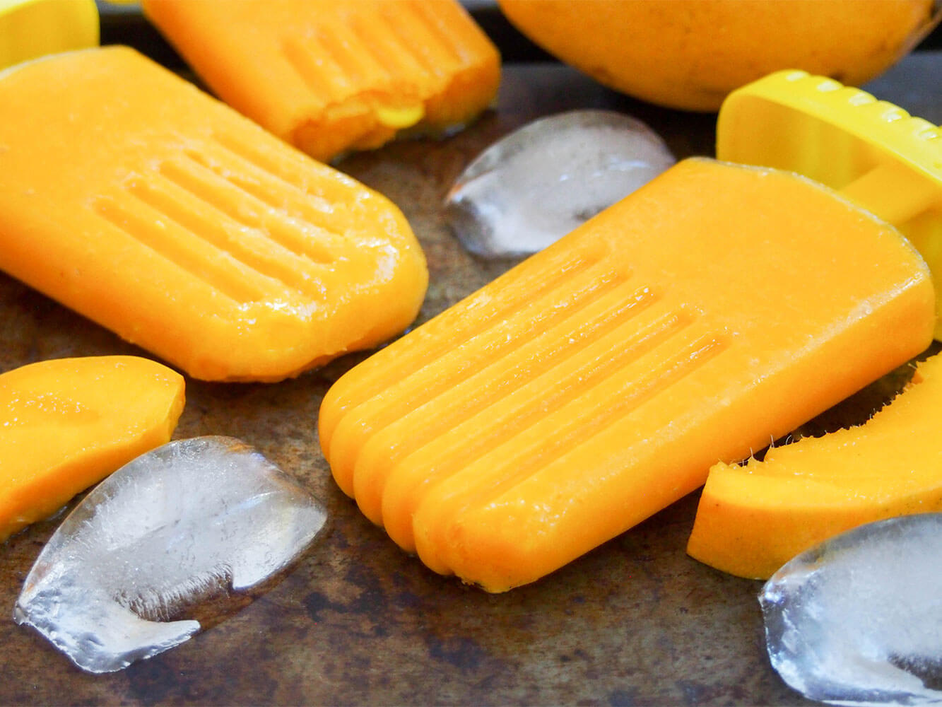 mango palatas (ice pops) on tray with ice to side