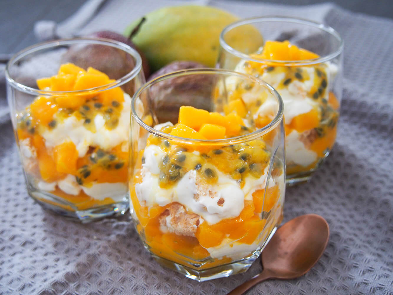 three glasses of mango passion fruit Eton mess