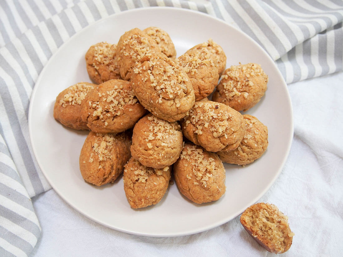 plate of melomakarona (Greek honey cookies) with one to side