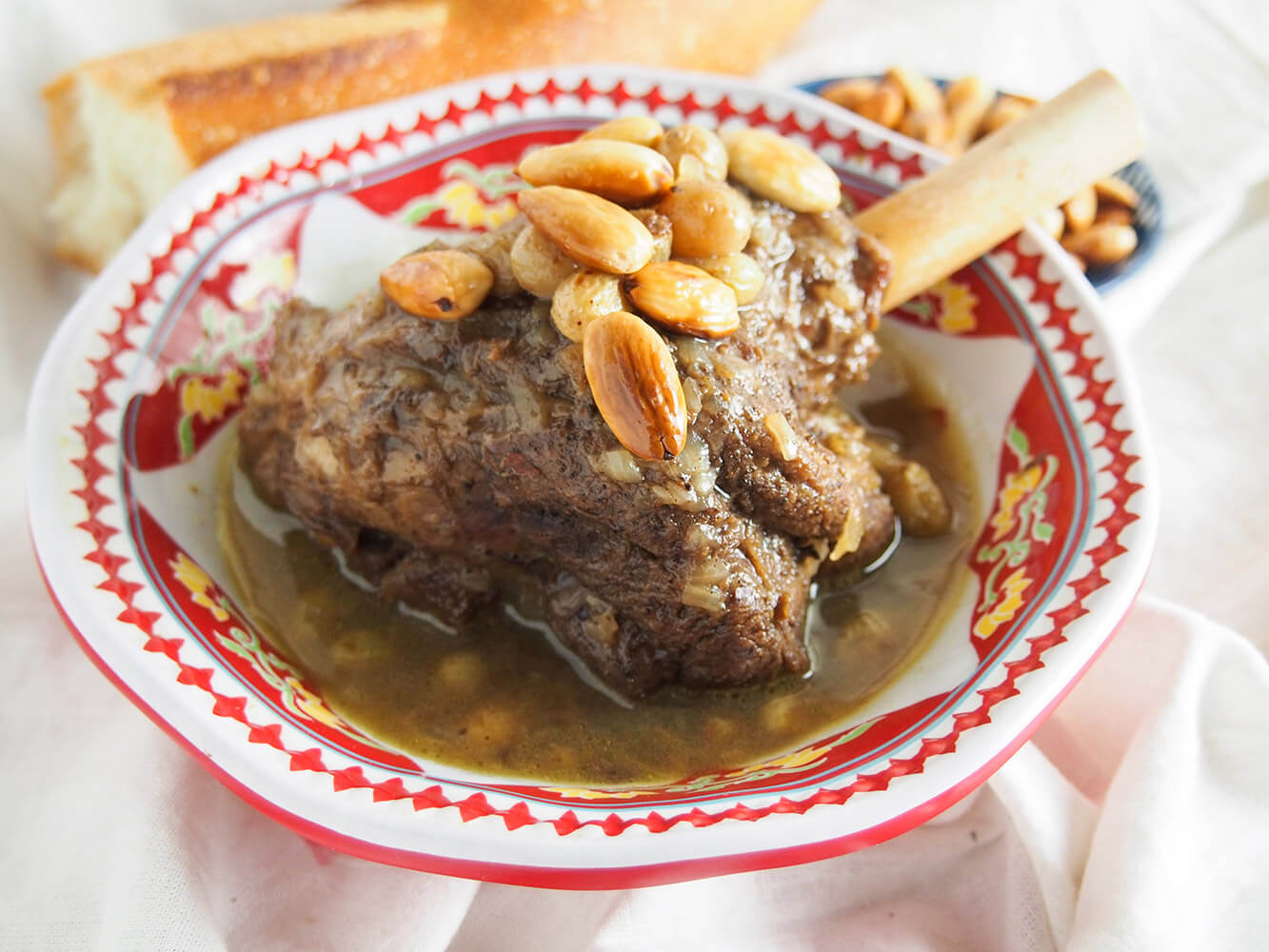 mrouzia honey lamb tagine in bowl topped with toasted almonds