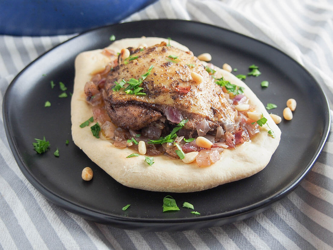 Musakhan (Palestinian sumac chicken) served on bread on a plate