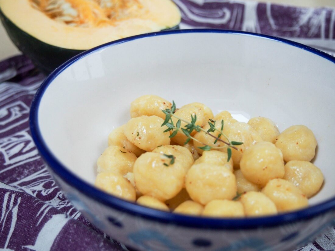 Bowl of acorn squash gnocchi with brown butter and thyme on top