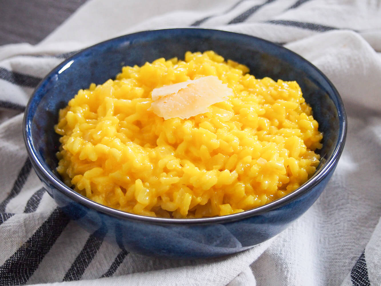 blue bowl filled with saffron risotto