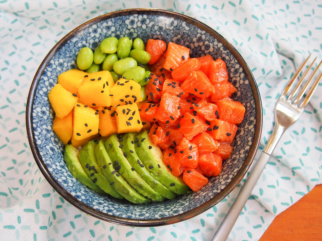 salmon poke bowl with fork to side of bowl