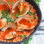 bowl of Sardinian fregola with clams close up