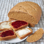 slices of Swedish limpa bread and part loaf hehind.