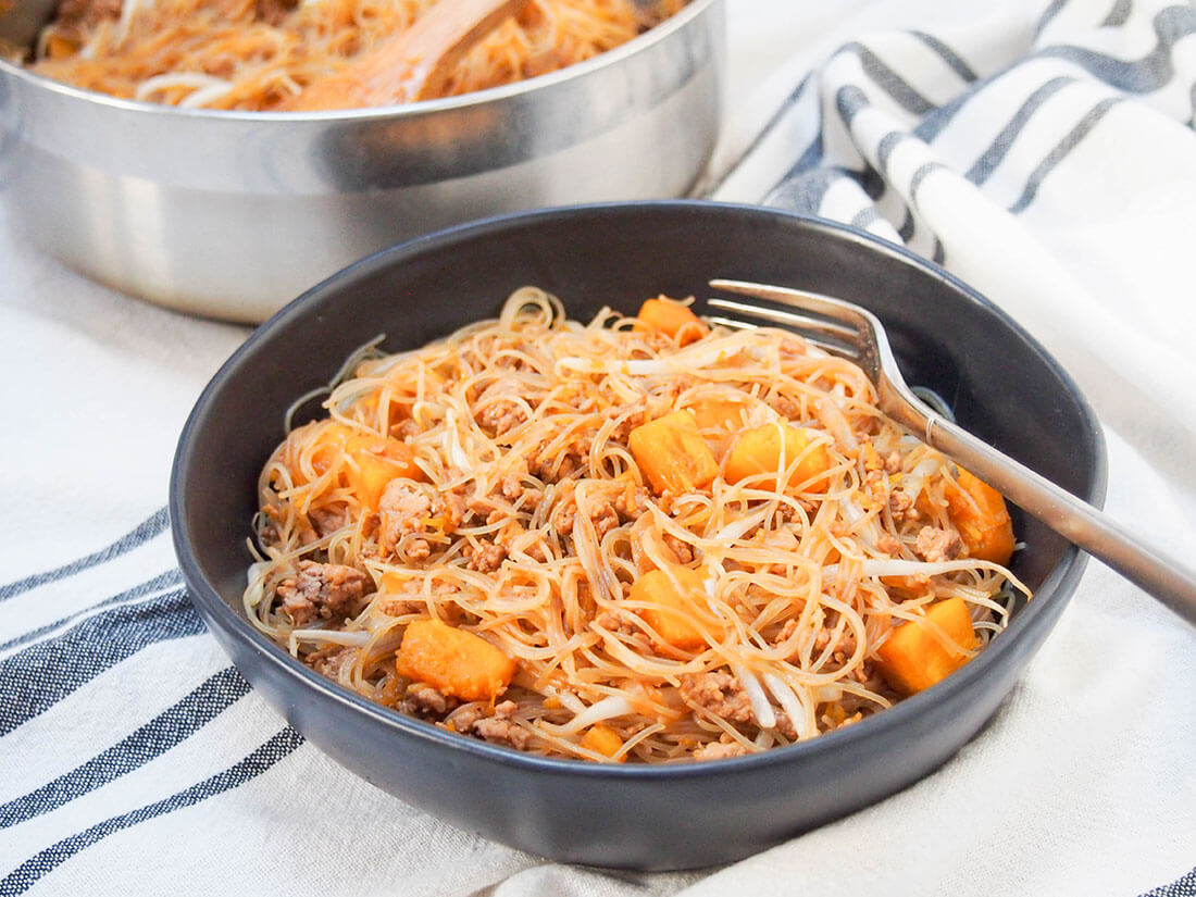 bowl of Taiwanese pumpkin rice noodles with fork in bowl