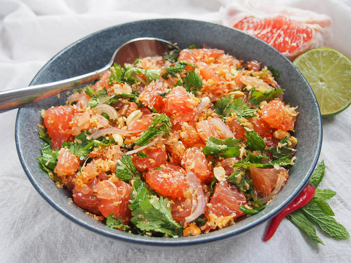 view from front of bowl of Thai pomelo salad with spoon at back of bowl