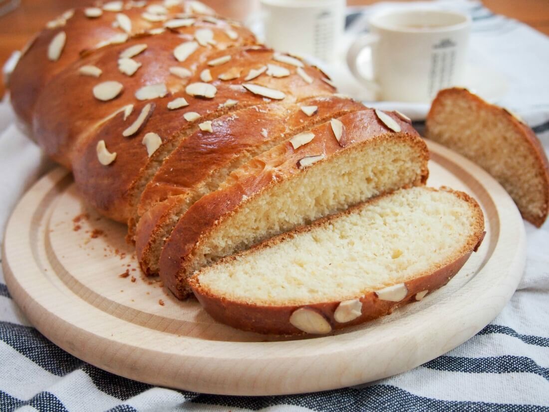 Tsoureki - Greek Easter bread with slices cut and one slice flat on board