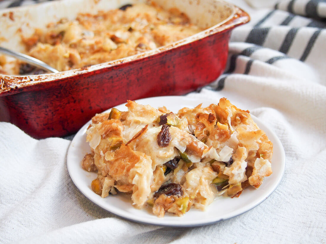 umm Ali Egyptian bread pudding served on plate in front of baking dish